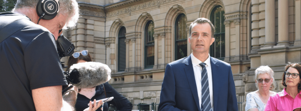 Jonathon Hunyor being interviewed in front of a court building.
